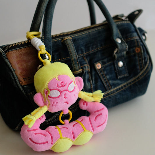 Yellow hair buff anime girl bag charm on a vintage denim handbag