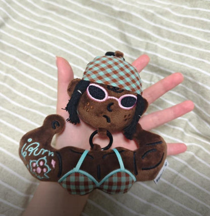 Close up of a cute aesthetic plush bag accessory resting on a hand