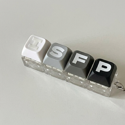 Minimalist ISFP personality type accessory styled as a mechanical keyboard keycap keychain