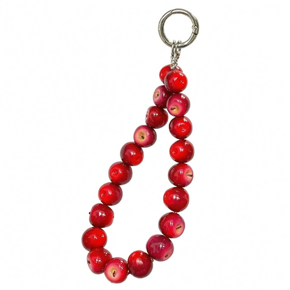 Red apple fruit phone charm held with a cozy grey sweater outfit