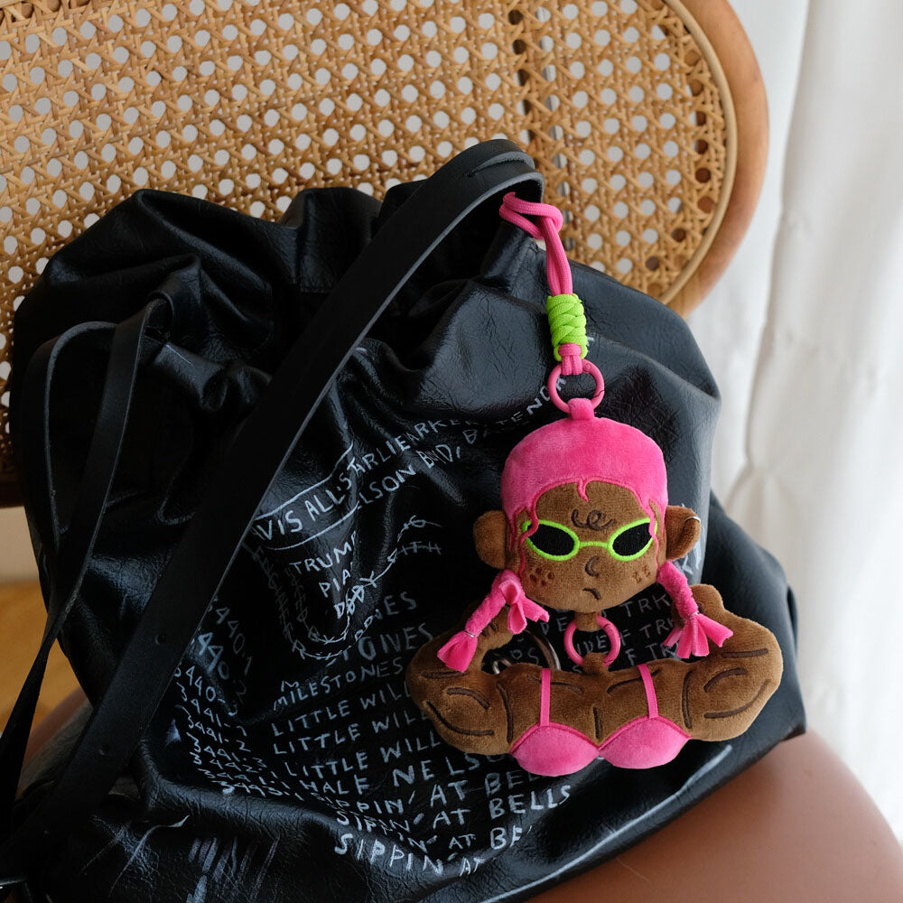 Pink bikini funny muscle girl plush keychain accessorizing a black bag