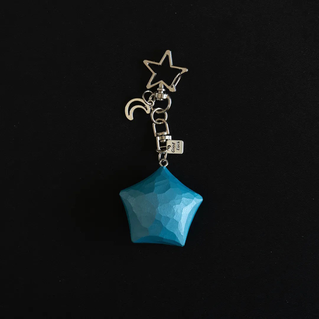 Blue hand-carved wooden star keychain with crescent moon charm and Good Luck metal tag