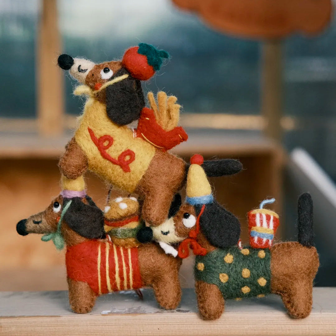 Three handmade wool felt dachshund bag charms with apple, burger and soda details