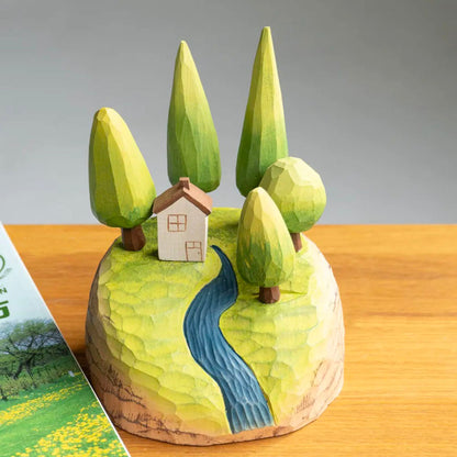 Miniature wooden forest scene with magnetic trees and cottage arranged on the landscape base