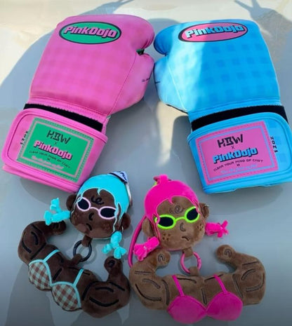 Funny muscle girl plush keychains displayed next to mini boxing gloves