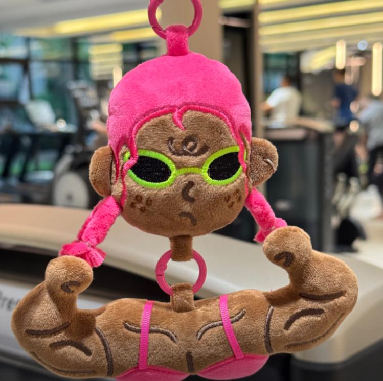 Close up of a pink hair buff anime girl bag charm with sunglasses