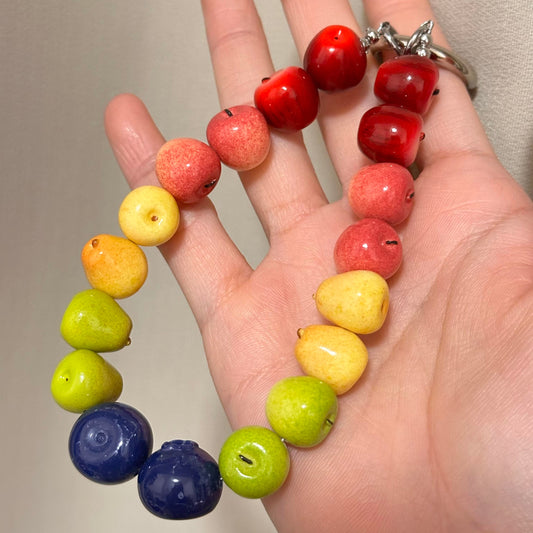 Colorful fruit beaded wristlet charm with mixed apple and blueberry-shaped beads and a metal ring.